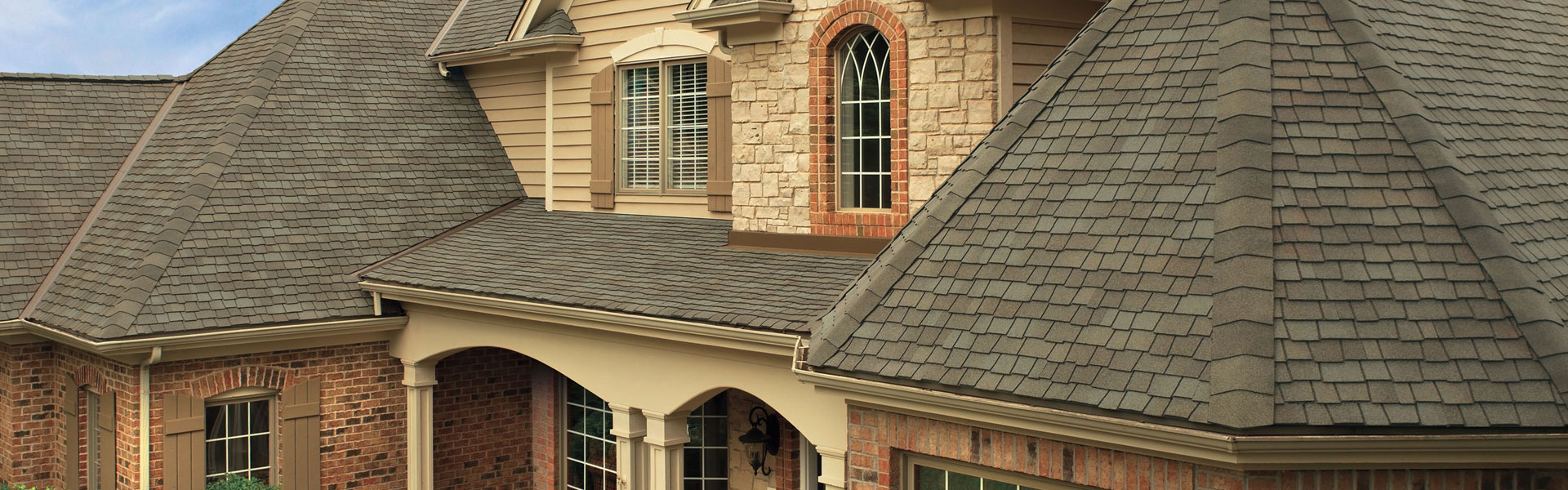 Home with a dark brown shingle roof